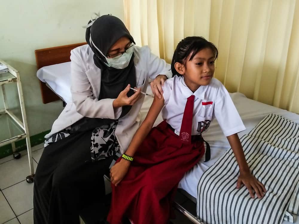 XSProject sponsored child getting an immunization shot